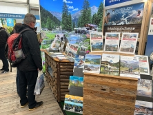 Prospektpräsentation am Messestand Urlaub in den Alpen